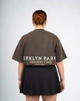 Back view of Brklyn Park Members Only Tee – oversized unisex brown t-shirt with bold back logo print