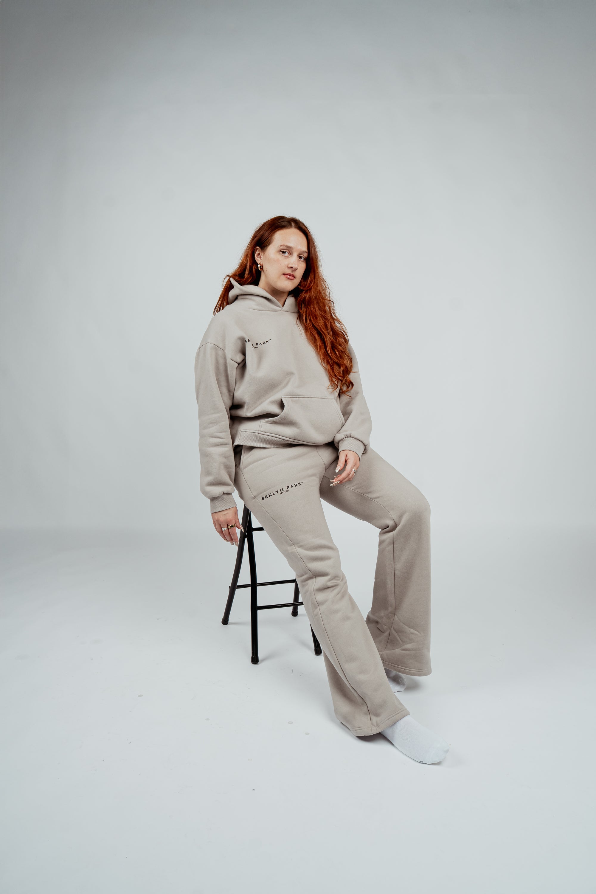 Female model wearing Brklyn Park Essence Fleece Sweatpants and matching hoodie in neutral gray, women’s fleece sweatpants minimalist loungewear