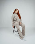 Female model wearing Brklyn Park Essence Fleece Sweatpants and matching hoodie in neutral gray, women’s fleece sweatpants minimalist loungewear