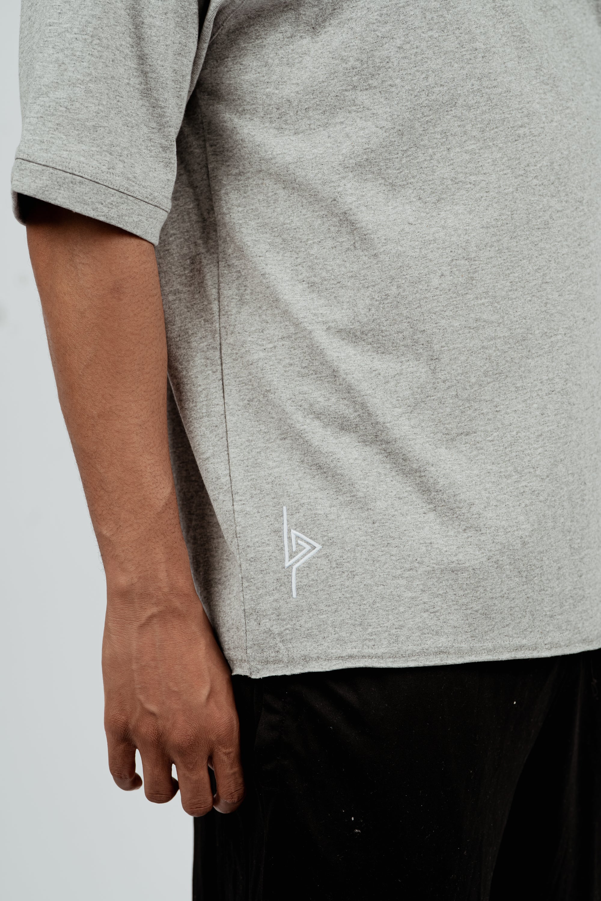 Close-up of side seam on gray Brklyn Park Sanchez Tee showing fabric texture and subtle logo detailing