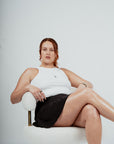 Brklyn Park woman’s ribbed white crop top and gray lounge pants set – minimalist neutral streetwear womens supreme streetwear model with red hair sitting in cloud chair