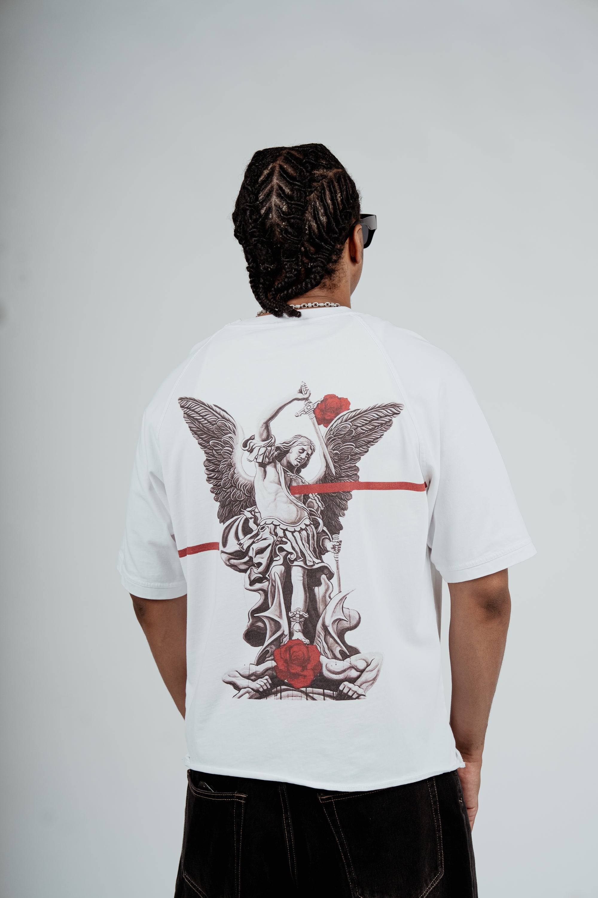 Model wearing the Brklyn Park Archangel Tee white oversized graphic t-shirt with angel artwork and red rose detailing, viewed from the back supreme streetwear