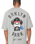 Straight back view of gray Sanchez Tee with bold Brklyn Park illustration and text graphic on oversized t-shirt