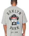 Straight back view of gray Sanchez Tee with bold Brklyn Park illustration and text graphic on oversized t-shirt