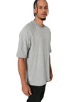 Male model wearing Brklyn Park Sanchez Tee in gray with minimalist front and oversized fit